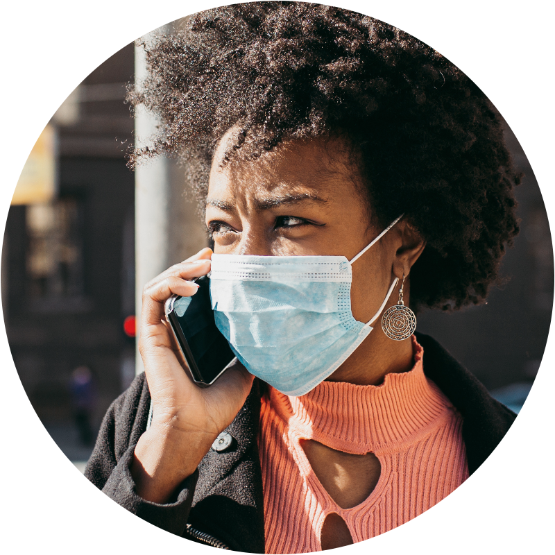 Person wearing mask for covid-19 protection while talking on a cell phone