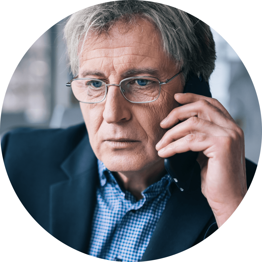 Business person on the phone looking off to the side with a very serious expression