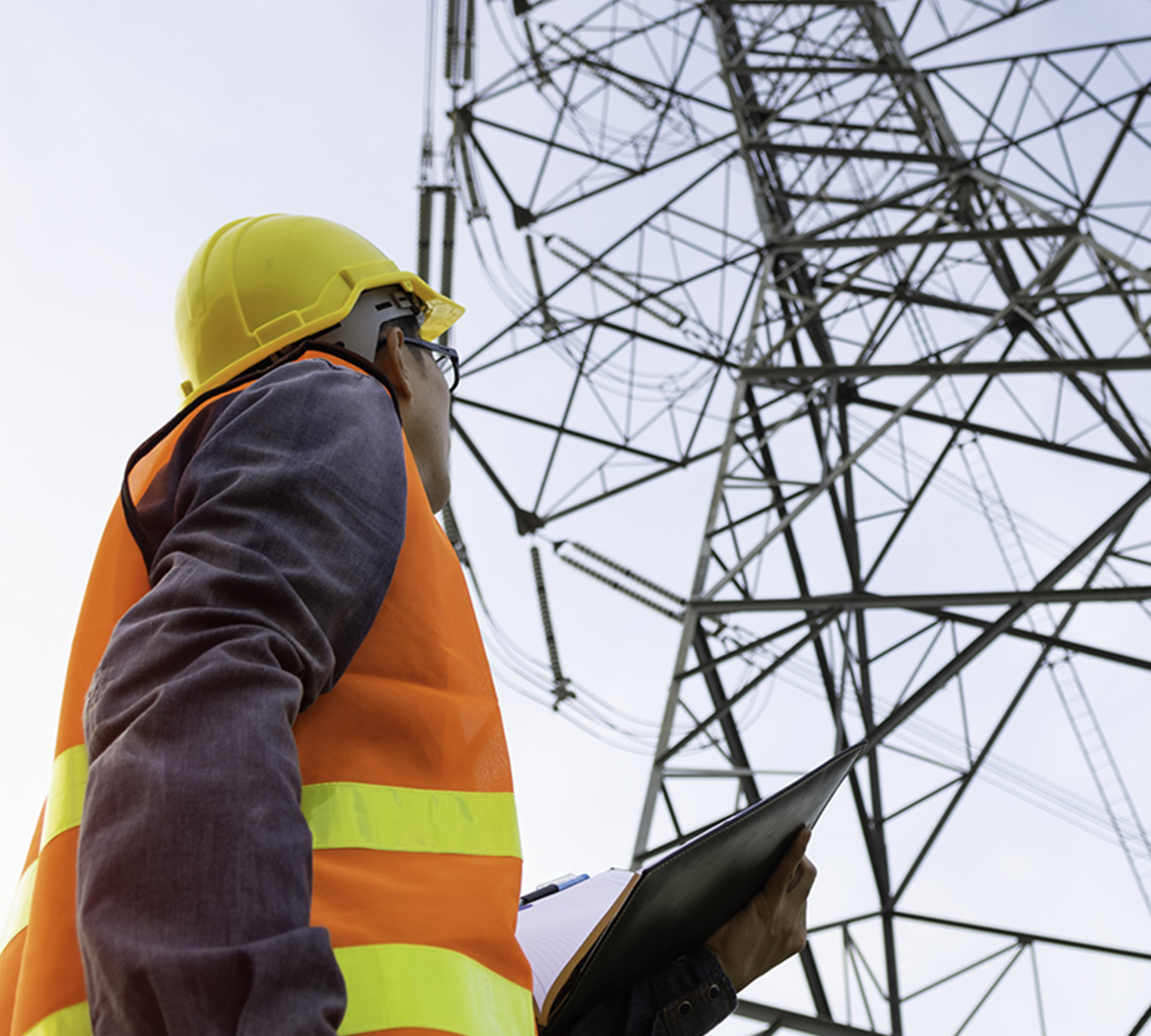 man looking at hydro lines, engineer looking at infrastructure