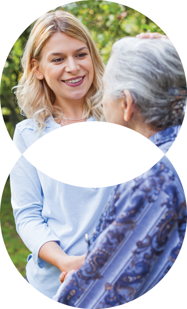 Daughter looking at their elderly mother with a smile