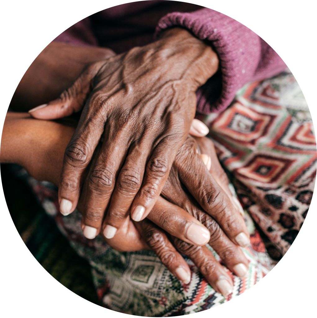 Close up of elderly hands holding another set of hands.