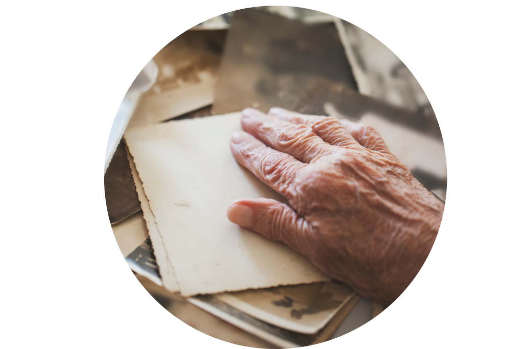 Elderly hand on top of post cards