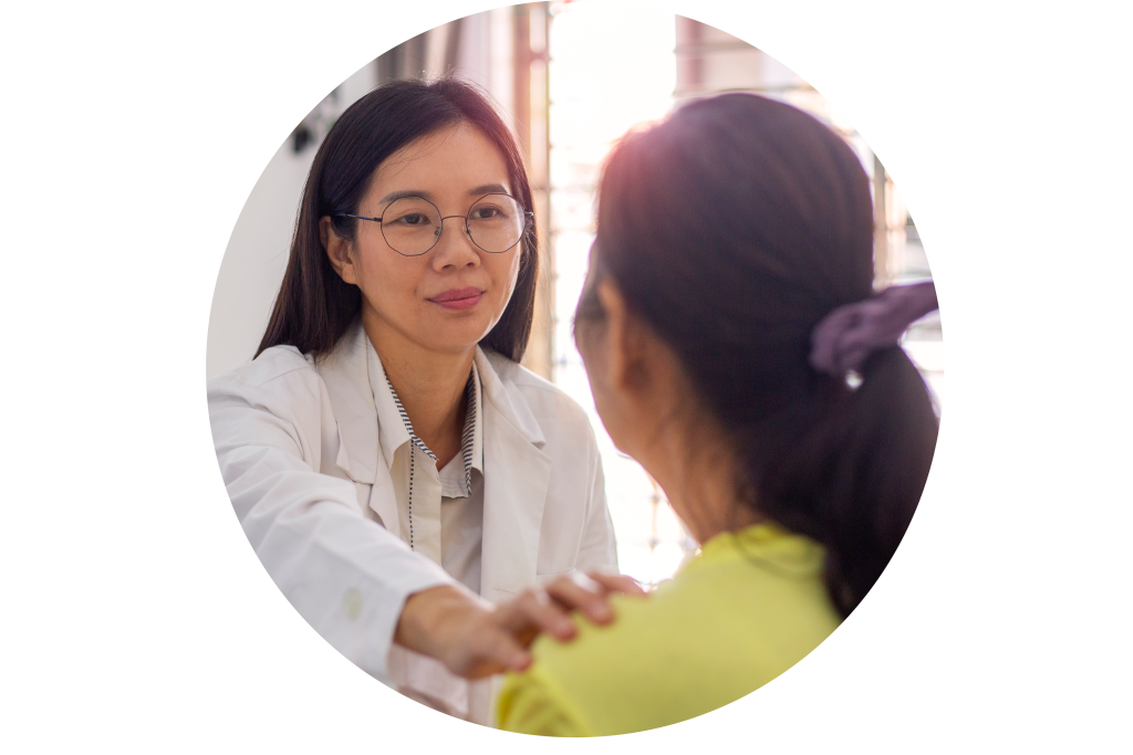 Doctor facing patient with hand on their shoulder