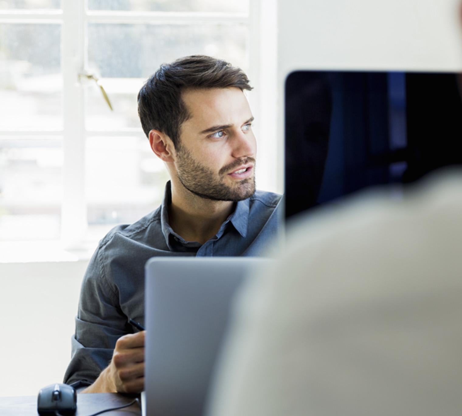 man at computer, person at computer, person looking away from computer