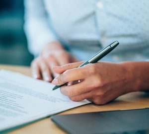 person writing, writing, person filling out a survey