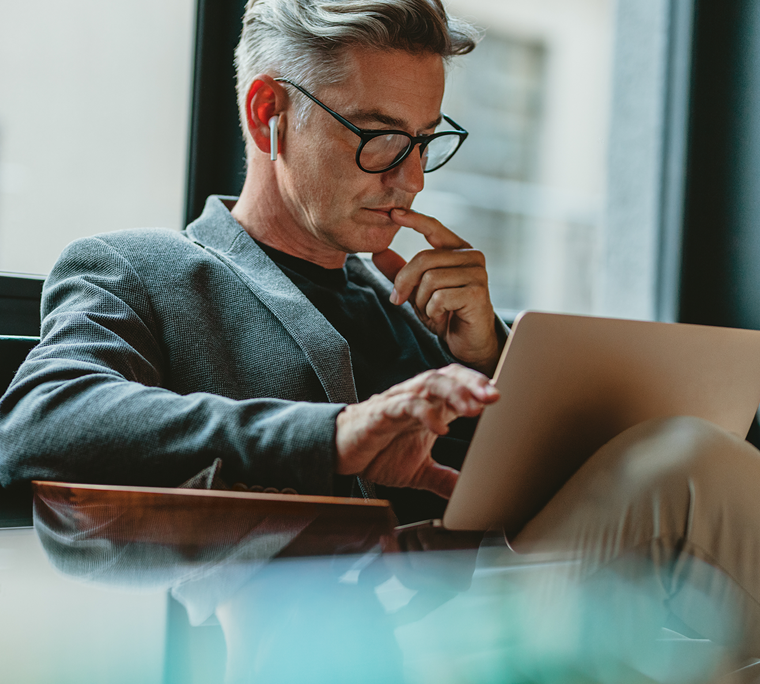 man on computer, man looking at computer, man reading on laptop, man on laptop