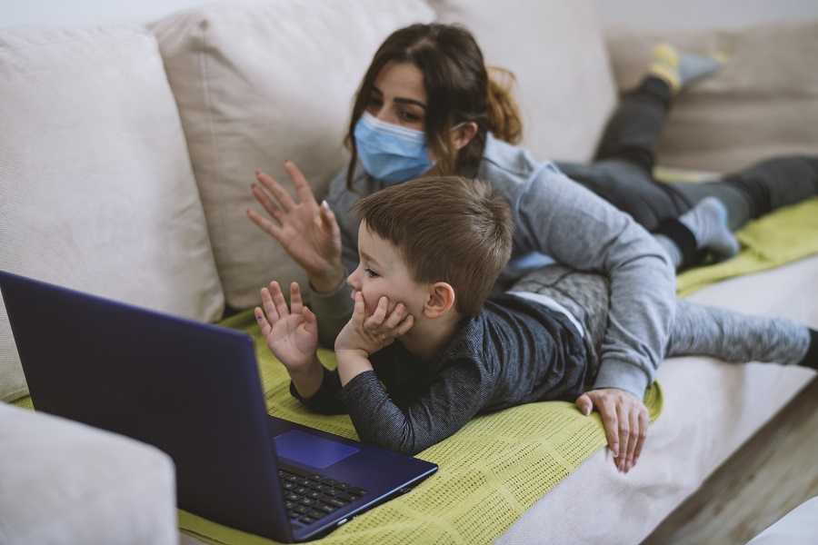 Mother and son making video call with father during lockdown