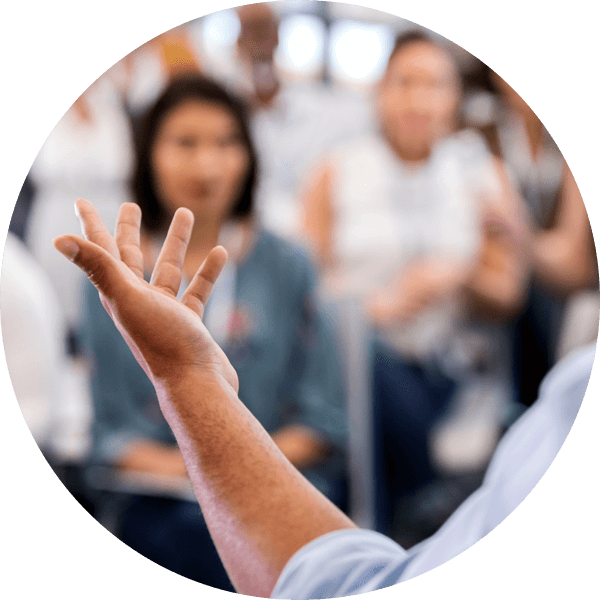 Hand gesturing in front of an audience