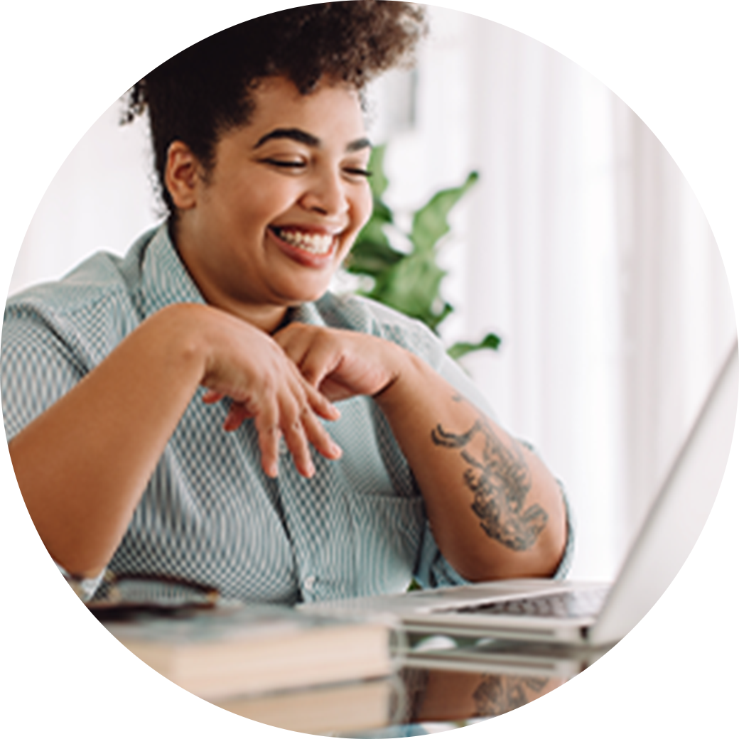 Woman smiling at her computer please with her work