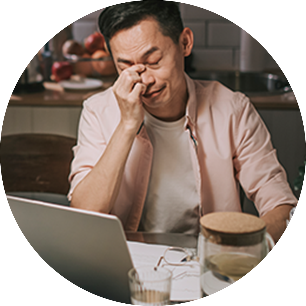 Man who has taken off is glasses in frustration and is pitching the bridge of his nose