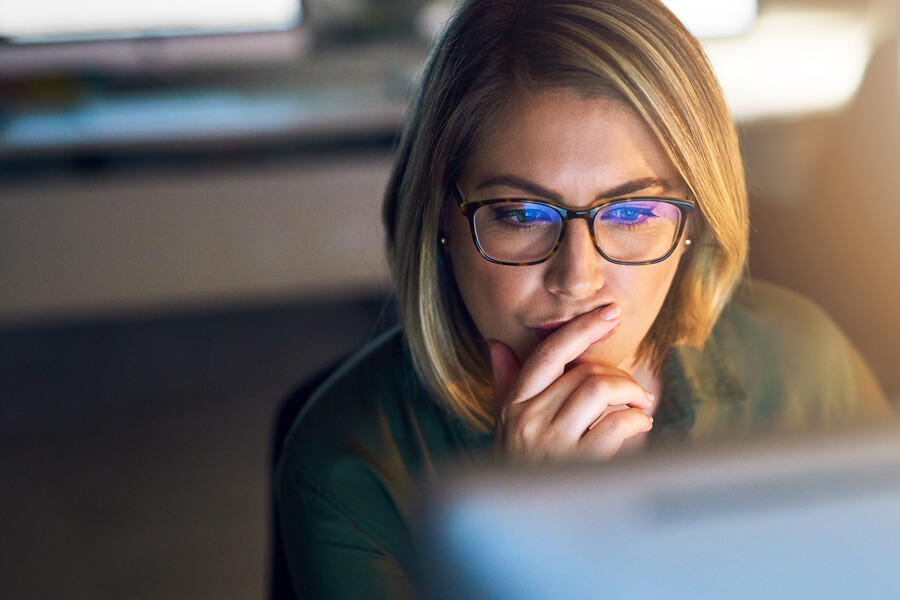 Concerned woman looking at computer screen