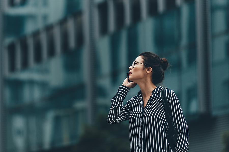 Woman on cell phone in front of office building
