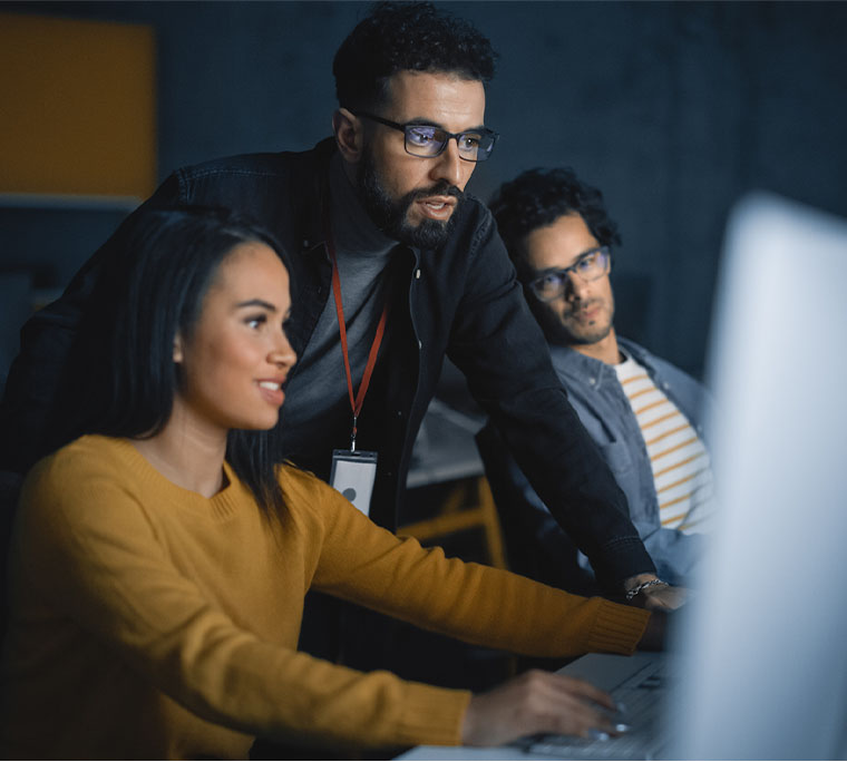 coworkers collaborating around a computer