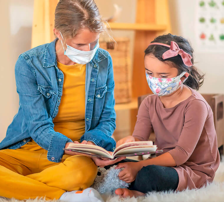 Woman teaching child to read