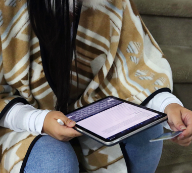Indigenous individual using tablet