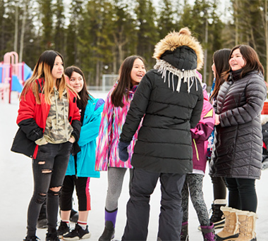 Group of Indigenous children standing in school field in a winter day