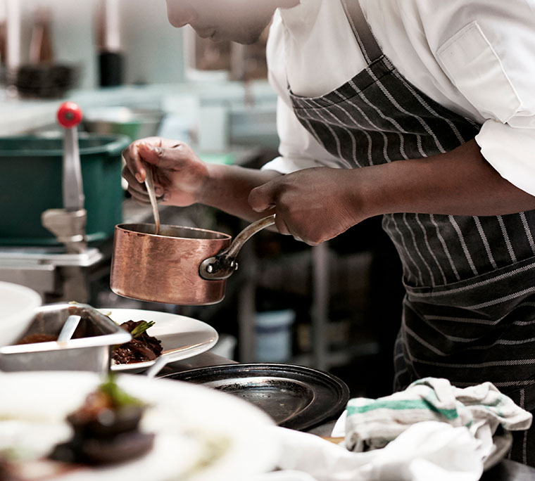 Chef finishing dishes at restaurant
