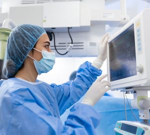 woman monitoring a screen in a hospital room