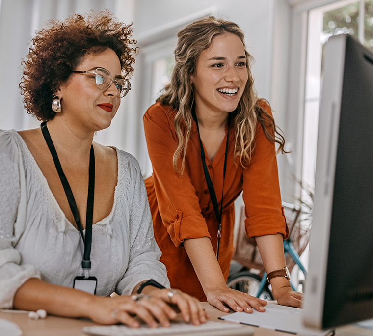 Two women working together at a computer