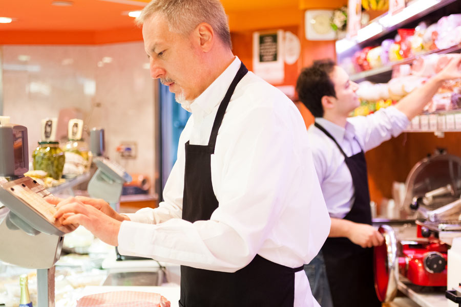 Two workers in a deli