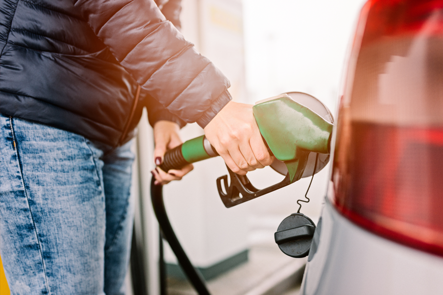 Person pumping gas into a car