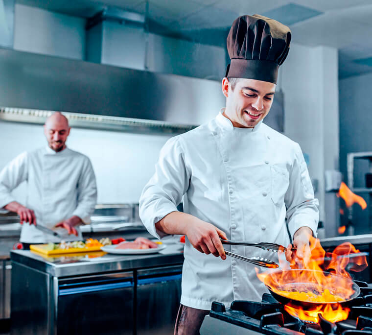 Two chefs working in a kitchen