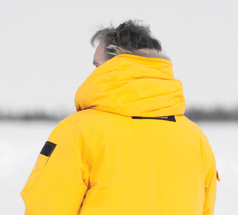 Person outside in winter wearing a yellow jacket