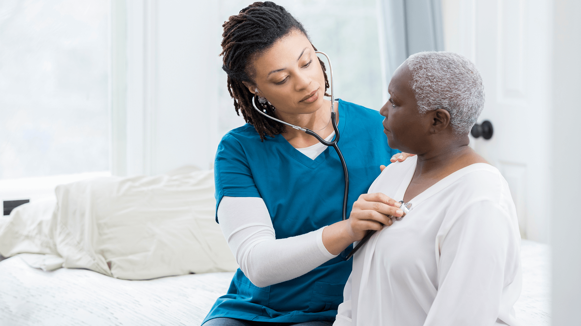 Nurse checking the heart rate of patient