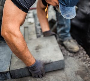 Builder laying stonework at new residential home