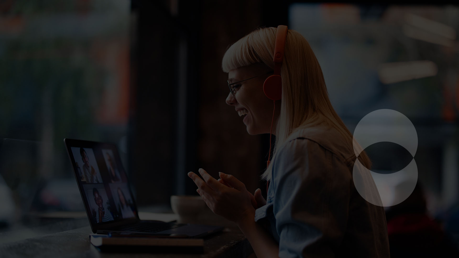 woman at laptop with headphones on