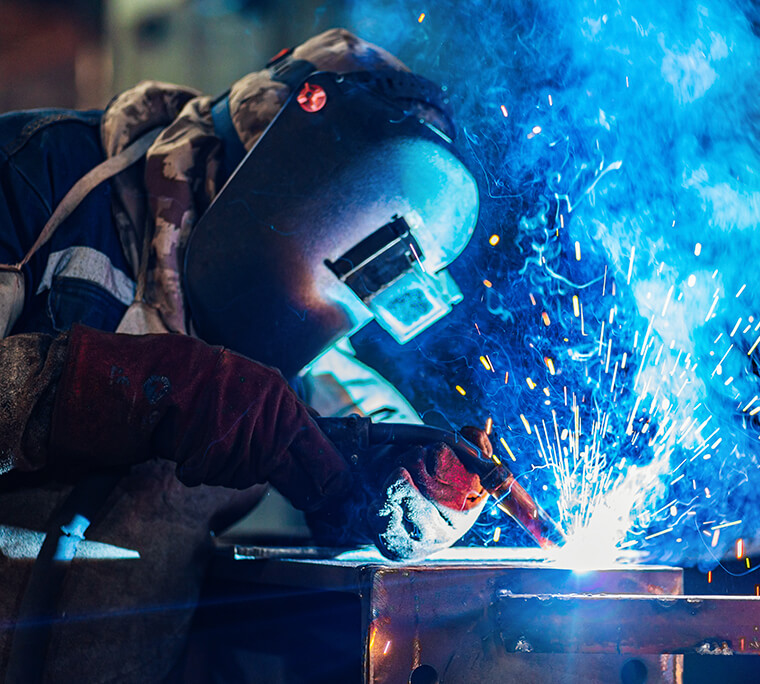 Person welding metal