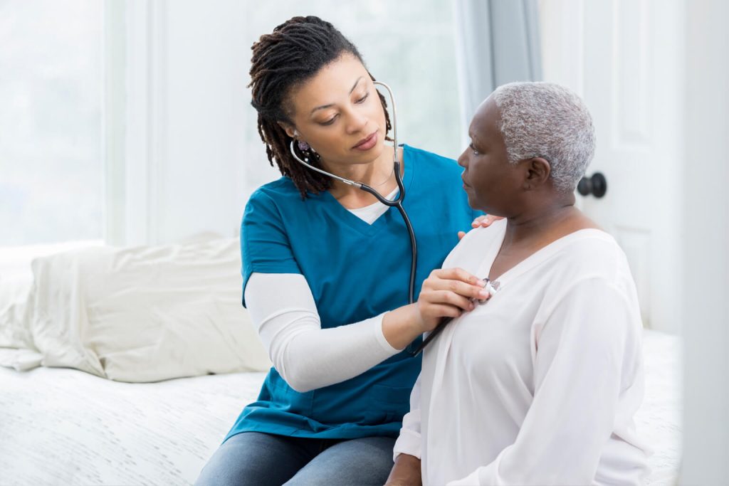 Nurse listening to patients heart
