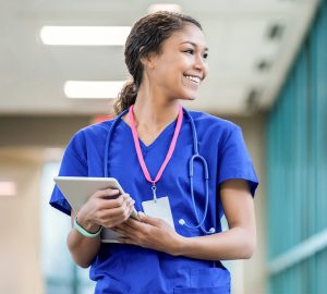 nurse looking out the hospital window smiling