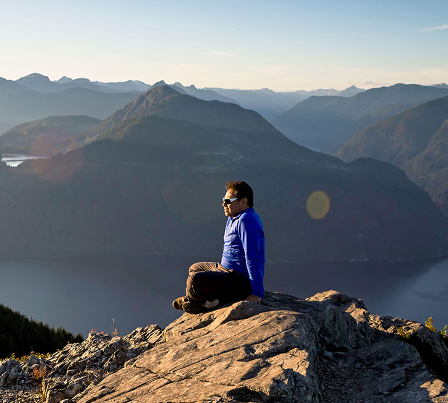 Man sitting on hill side