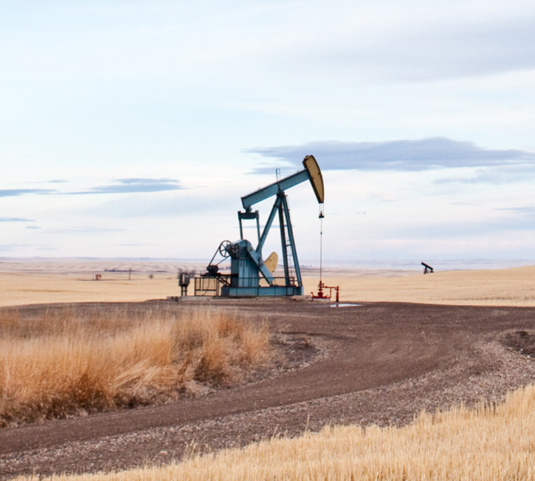 An oil rig in the prairies on a clear day